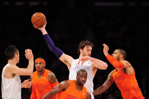 Pau Gasol (C) of the Los Angeles Lakers grabs the ball against the New York Knicks on December 25, 2012 Pau Gasol (C) of the Los Angeles Lakers grabs the ball against the New York Knicks on December 25, 2012