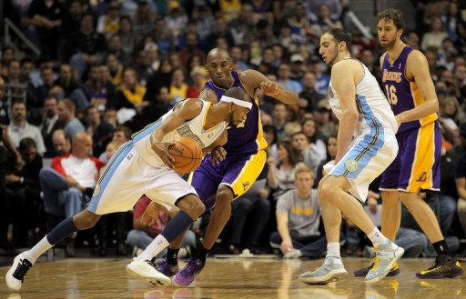 Corey Brewer of the Denver Nuggets slips past Kobe Bryant of the Los Angeles Lakers at Pepsi Center on December 26, 2012 Corey Brewer of the Denver Nuggets slips past Kobe Bryant of the Los Angeles Lakers at Pepsi Center on December 26, 2012