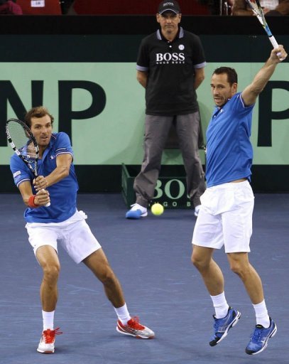 France's Julien Benneteau (L) and Michael Llodra play Davis Cup doubles on February 2, 2012 in Rouen France's Julien Benneteau (L) and Michael Llodra play Davis Cup doubles on February 2, 2012 in Rouen