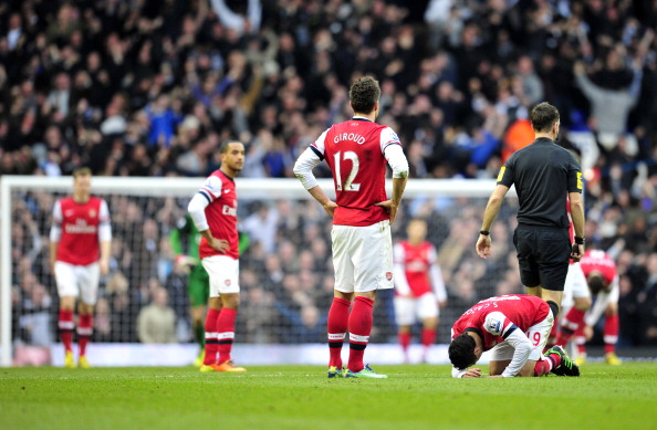 Arsenals players react after conceding the second goal during the English Premier League football match between Tottenham Hotspur and Arsenal at White Hart Lane in north London on March 3, 2013.