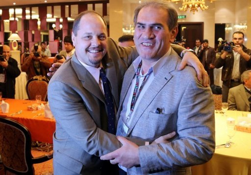 USA Wrestling's Rich Bender (L) poses with Iran’s wrestling federation head Hojatollah Khatib on February 20, 2013 USA Wrestling's Rich Bender (L) poses with Iran’s wrestling federation head Hojatollah Khatib on February 20, 2013