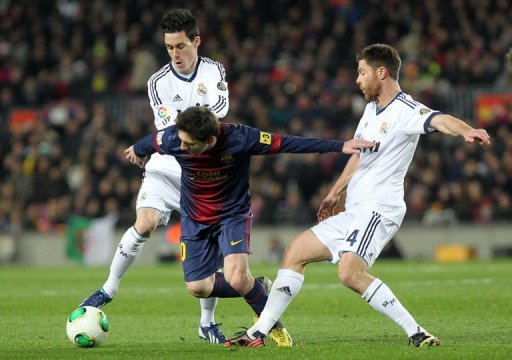 Barcelona's Lionel Messi tries to find a way through Real Madrid's Jose Callejon (L) and Xabi Alonso February 26, 2013 Barcelona's Lionel Messi tries to find a way through Real Madrid's Jose Callejon (L) and Xabi Alonso February 26, 2013