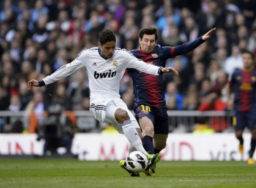 Real Madrid's Raphael Varane clashes with Barcelona's Lionel Messi in Madrid, March 2, 2013 Real Madrid's Raphael Varane clashes with Barcelona's Lionel Messi in Madrid, March 2, 2013