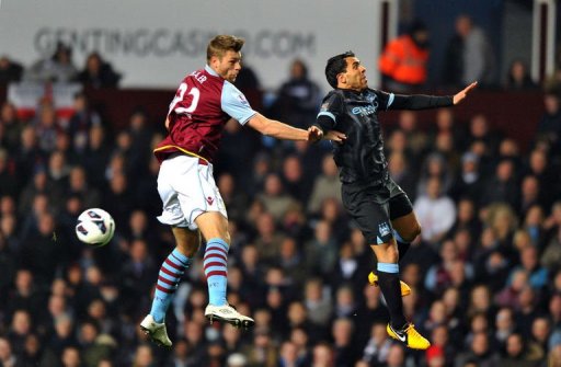 Manchester City's Carlos Tevez (R) jumps with Aston Villa's Nathan Baker in Birmingham on March 4, 2013 Manchester City's Carlos Tevez (R) jumps with Aston Villa's Nathan Baker in Birmingham on March 4, 2013