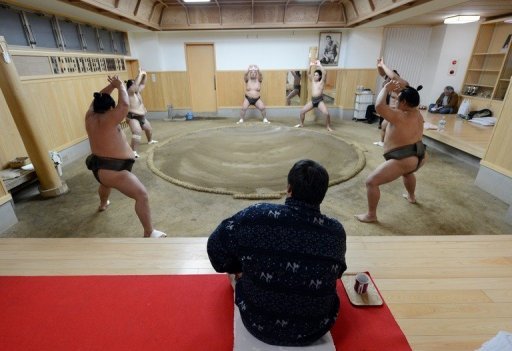 Stablemaster Tadahiro Otake (seated) watches as his sumo wrestlers train at a sumo stable in Tokyo on February 14, 2013 Stablemaster Tadahiro Otake (seated) watches as his sumo wrestlers train at a sumo stable in Tokyo on February 14, 2013