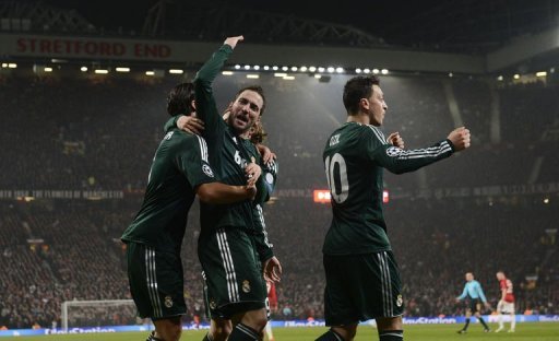 Real Madrid's Gonzalo Higuain (C) celebrates setting up his team's second goal at Old Trafford on March 5, 2013 Real Madrid's Gonzalo Higuain (C) celebrates setting up his team's second goal at Old Trafford on March 5, 2013