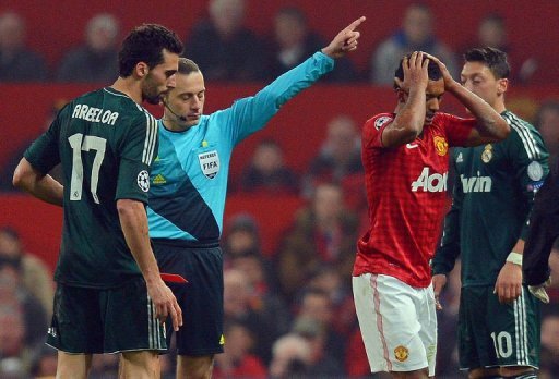 United midfielder Nani (R) holds his head as referee Cuneyt Cakir sends him off at Old Trafford on March 5, 2013 United midfielder Nani (R) holds his head as referee Cuneyt Cakir sends him off at Old Trafford on March 5, 2013
