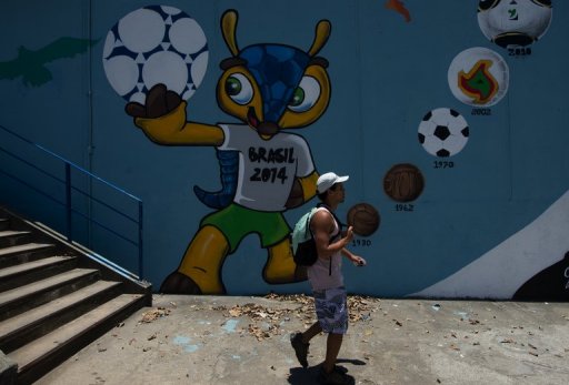 A man walks next to a mural depicting A man walks next to a mural depicting