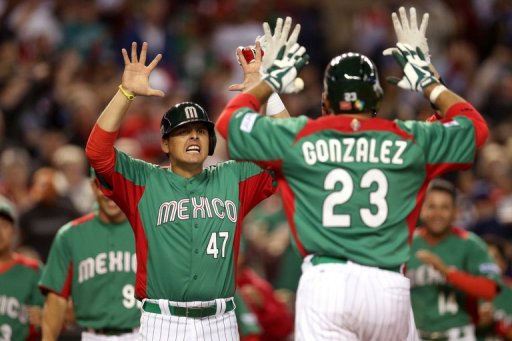 Mexico's Luis Cruz (L) congratulates teammate Adrian Gonzalez, at Chase Field in Phoenix, Arizona, on March 8, 2013 Mexico's Luis Cruz (L) congratulates teammate Adrian Gonzalez, at Chase Field in Phoenix, Arizona, on March 8, 2013