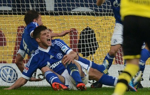 Schalke's Klaas-Jan Huntelaar holds his knee after going down on March 9, 2013 Schalke's Klaas-Jan Huntelaar holds his knee after going down on March 9, 2013