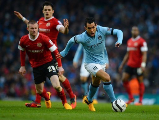 Manchester City forward Carlos Tevez gets away from Barnsley's Ryan Tunnicliffe on March 9, 2013 Manchester City forward Carlos Tevez gets away from Barnsley's Ryan Tunnicliffe on March 9, 2013