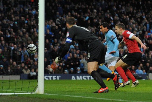 Manchester City forward Carlos Tevez scores the opening goal against Barnsley on March 9, 2013 Manchester City forward Carlos Tevez scores the opening goal against Barnsley on March 9, 2013