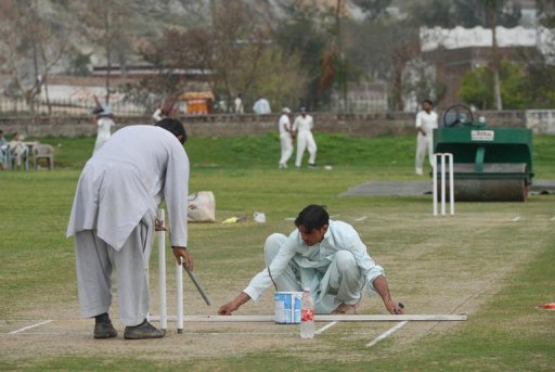 Ground staff prepare a pitch in northwest Swabi, the hometown of a Pakistani cricketer Fawad Ahmed on March 9, 2013 Ground staff prepare a pitch in northwest Swabi, the hometown of a Pakistani cricketer Fawad Ahmed on March 9, 2013