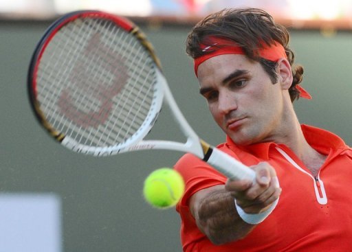 Roger Federer hits a forehand return against Ivan Dodig at Indian Wells on March 11, 2013 Roger Federer hits a forehand return against Ivan Dodig at Indian Wells on March 11, 2013