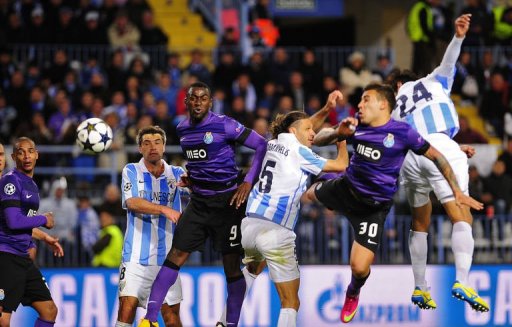 Malaga's Roque Santa Cruz (R) scores the second goal in Malaga on March 13, 2013 Malaga's Roque Santa Cruz (R) scores the second goal in Malaga on March 13, 2013