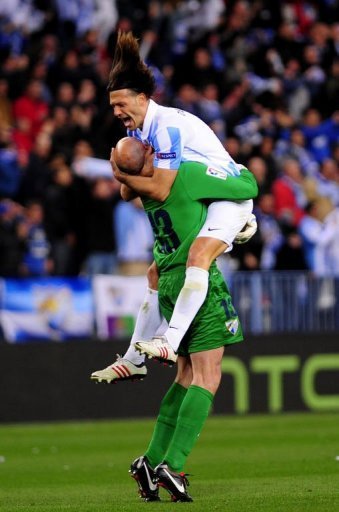 Malaga's Martin Demichelis (R) and goalkeeper Willy Caballero (L) celebrate in Malaga on March 13, 2013 Malaga's Martin Demichelis (R) and goalkeeper Willy Caballero (L) celebrate in Malaga on March 13, 2013