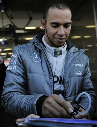 Lewis Hamilton signs autographs during testing on February 20, 2013 Lewis Hamilton signs autographs during testing on February 20, 2013
