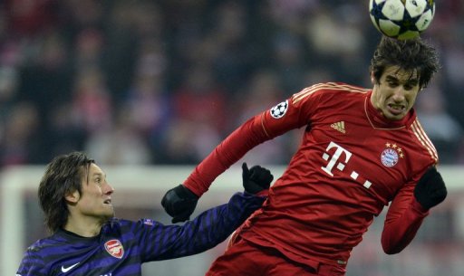 Bayern Munich's Javier Martinez out-jumps Tomas Rosicky during the UEFA Champions League match on March 13, 2013 Bayern Munich's Javier Martinez out-jumps Tomas Rosicky during the UEFA Champions League match on March 13, 2013