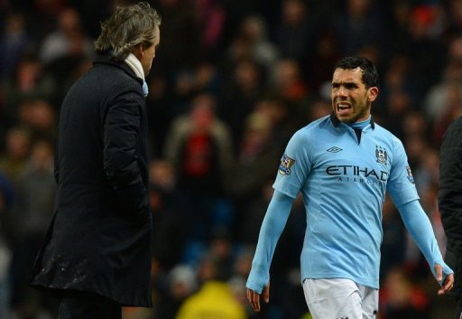 Manchester City's Carlos Tevez speaks to manager Roberto Mancini during the match against Barnsley March 9, 2013 Manchester City's Carlos Tevez speaks to manager Roberto Mancini during the match against Barnsley March 9, 2013