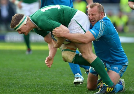 Ireland's centre Brian O'Driscoll (L) is tackled by Italy's hooker Leonardo Ghiraldini in Rome on March 16, 2013 Ireland's centre Brian O'Driscoll (L) is tackled by Italy's hooker Leonardo Ghiraldini in Rome on March 16, 2013