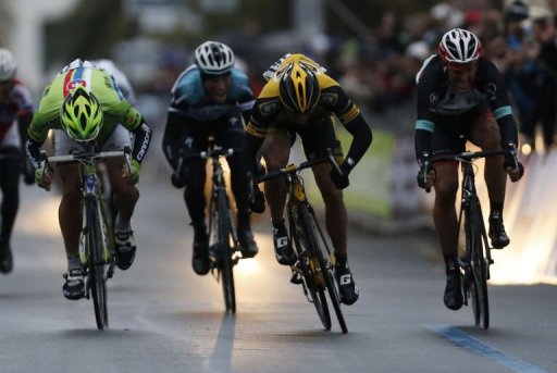 Gerald Ciolek (yellow) crosses the finish line to win the 104th Milan San Remo spring classic on March 17, 2013 Gerald Ciolek (yellow) crosses the finish line to win the 104th Milan San Remo spring classic on March 17, 2013