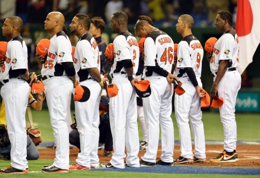 Netherlands manager Hensley Meulens (R) and players listen to the national anthem ahead of a WBC game on March 10, 2013 Netherlands manager Hensley Meulens (R) and players listen to the national anthem ahead of a WBC game on March 10, 2013