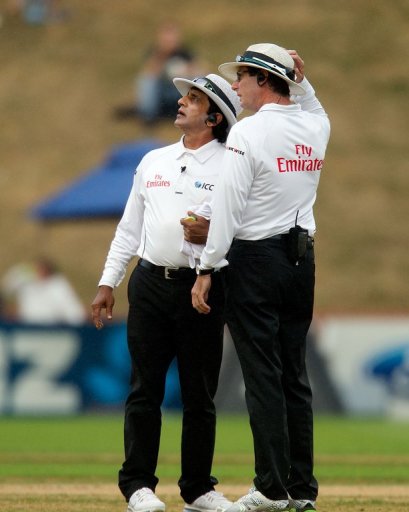 Umpires Asad Rauf (L) and RJ Tucker gauge the weather in Wellington on March 17, 2013 Umpires Asad Rauf (L) and RJ Tucker gauge the weather in Wellington on March 17, 2013