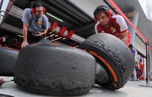 Ferrari crew look at wear on tyres in Sepang on March 22, 2013 during practice for the Malaysian Grand Prix Ferrari crew look at wear on tyres in Sepang on March 22, 2013 during practice for the Malaysian Grand Prix