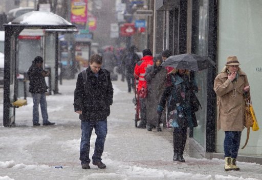 Pedestrians walk through the snow in Belfast City centre in Northern Ireland, on March 22, 2013 Pedestrians walk through the snow in Belfast City centre in Northern Ireland, on March 22, 2013