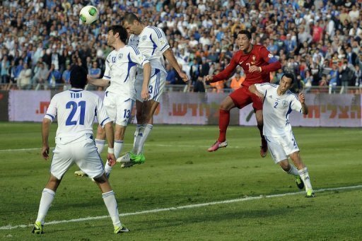 Portuguese forward Cristiano Ronaldo (R) goes up for a high ball against a packed Israel defence on March 22, 2013 Portuguese forward Cristiano Ronaldo (R) goes up for a high ball against a packed Israel defence on March 22, 2013