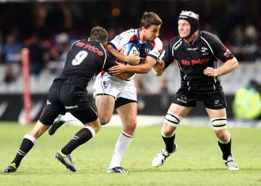 Nick Phipps of the Rebels (C) is tackled by Cobus Reinach (L) and Franco van der Merwe (R) of the Sharks, March 23, 2013 Nick Phipps of the Rebels (C) is tackled by Cobus Reinach (L) and Franco van der Merwe (R) of the Sharks, March 23, 2013