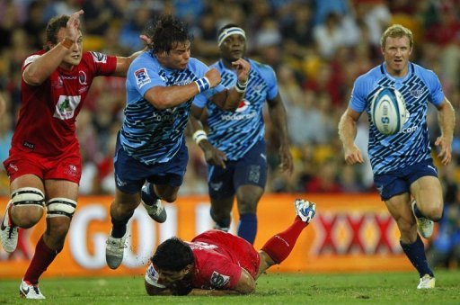 Northern Bulls' Johannes Engelbrecht gets a pass away as he is tackled by Queensland Reds' Ben Tapuai, on March 23, 2013 Northern Bulls' Johannes Engelbrecht gets a pass away as he is tackled by Queensland Reds' Ben Tapuai, on March 23, 2013