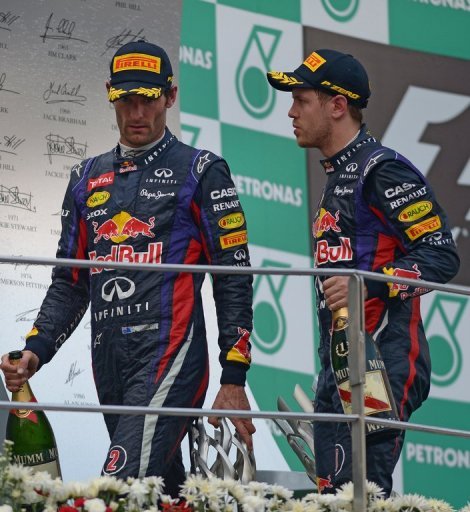 Malaysian Grand Prix winner Sebastian Vettel (R) leaves the podium with his teammate Mark Webber on March 24, 2013 Malaysian Grand Prix winner Sebastian Vettel (R) leaves the podium with his teammate Mark Webber on March 24, 2013