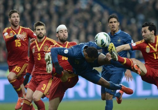 France defender Patrice Evra heads the ball away from the stretching Alvaro Arbeloa on March 26, 2013 France defender Patrice Evra heads the ball away from the stretching Alvaro Arbeloa on March 26, 2013