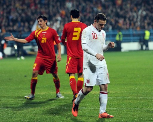 England forward Wayne Rooney (R) trudges off after the draw at Montenegro on March 26, 2013 England forward Wayne Rooney (R) trudges off after the draw at Montenegro on March 26, 2013