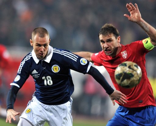 Kenny Miller (L) battles with Branislav Ivanovic during their World Cup qualifier on March 26, 2013 Kenny Miller (L) battles with Branislav Ivanovic during their World Cup qualifier on March 26, 2013