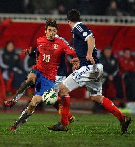 Serbia's Filip Djuricic (L) runs at the Scotland defence on March 26, 2013 Serbia's Filip Djuricic (L) runs at the Scotland defence on March 26, 2013