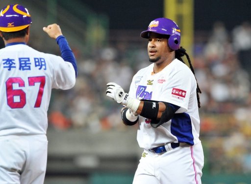 Manny Ramirez, former Boston Red Sox slugger, reacts to a team coach in his debut game in Kaohsiung on March 27, 2013 Manny Ramirez, former Boston Red Sox slugger, reacts to a team coach in his debut game in Kaohsiung on March 27, 2013