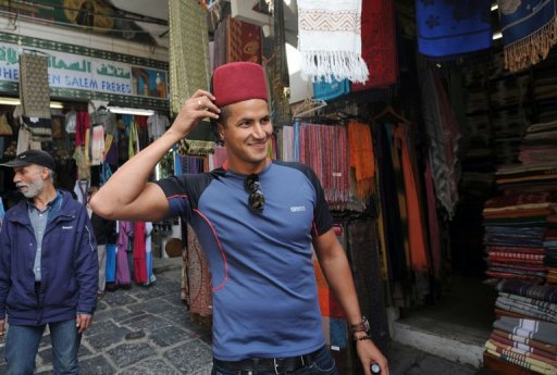 Olympic champion Oussama Mellouli visits the souk in Tunis on March 22, 2013 Olympic champion Oussama Mellouli visits the souk in Tunis on March 22, 2013
