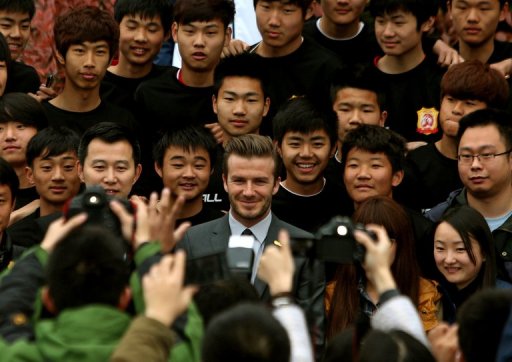 David Beckham (C) poses for a photo with young Chinese players at the Zall Football Club in Wuhan on March 23, 2013 David Beckham (C) poses for a photo with young Chinese players at the Zall Football Club in Wuhan on March 23, 2013