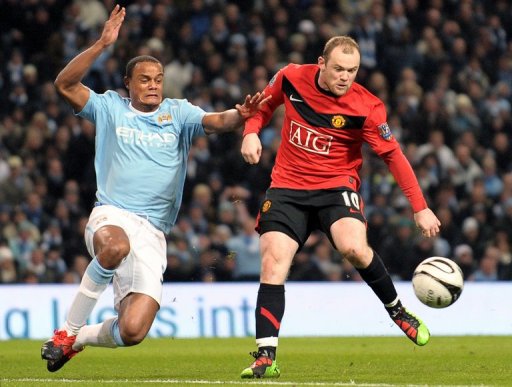 Manchester United's Wayne Rooney (right) and Manchester City's Vincent Kompany on January 19, 2010 Manchester United's Wayne Rooney (right) and Manchester City's Vincent Kompany on January 19, 2010