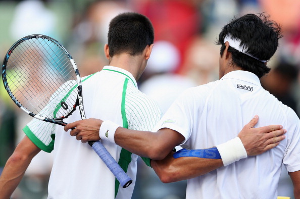 KEY BISCAYNE, FL - MARCH 24: Novak Djokovic of Serbia walks off court after shaking hands at the net after his straight victory against Somdev Devvarman of India during their third round match at the Sony Open at Crandon Park Tennis Center