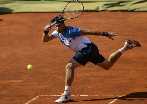 Spanish player David Ferrer returns the ball to Romanian player Victor Hanescu in Oeiras on May 3, 2013 Spanish player David Ferrer returns the ball to Romanian player Victor Hanescu in Oeiras on May 3, 2013
