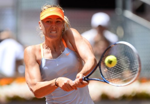 Maria Sharapova returns a ball to Kaia Kanepi during their match at the Madrid Masters in Madrid on May 10, 2013 Maria Sharapova returns a ball to Kaia Kanepi during their match at the Madrid Masters in Madrid on May 10, 2013