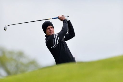 English golfer Luke Donald plays his approach shot to the 1st green in Surrey, England, on May 24, 2013 English golfer Luke Donald plays his approach shot to the 1st green in Surrey, England, on May 24, 2013
